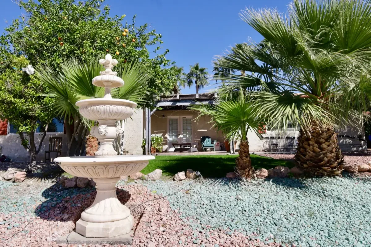 Fountain and palm trees in the courtyard at Living Longer Recovery